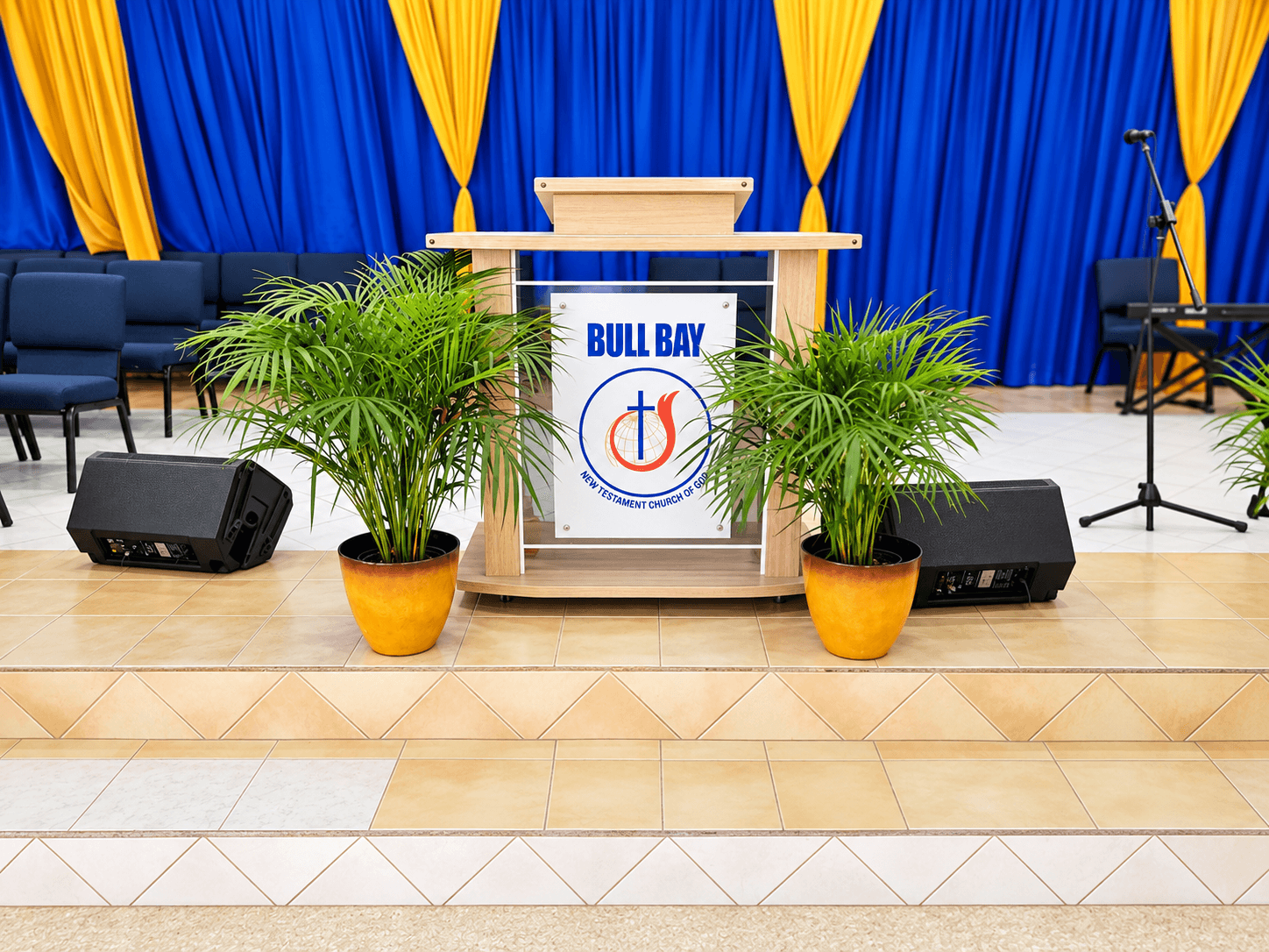 The Bull Bay church pulpit framed by palms and blue and gold curtains