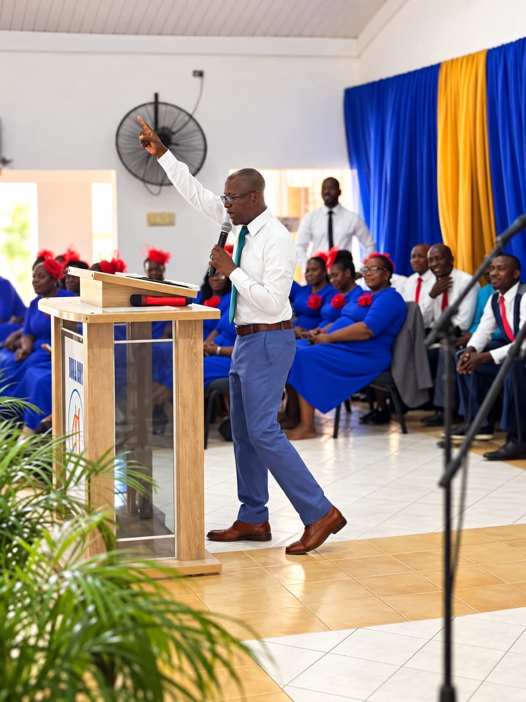 Rev. Dr. Kevin Page preaching at Bull Bay, with the choir seated behind him